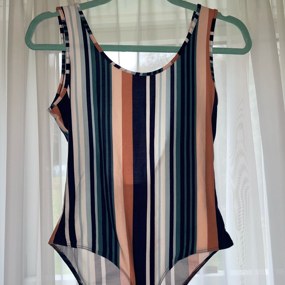 Body suit with clasps. Never worn. Soo buttery soft just not my style